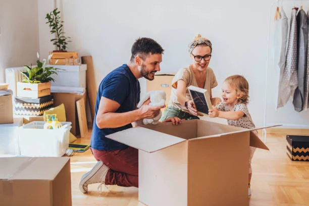 Professional movers carefully packing boxes for an international relocation